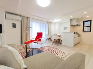a living room with a couch and a table at LANG Hotel Ginza 1LDK in Tokyo