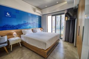 a bedroom with a bed and a blue wall at Island Boutique Hotel in Rhodes Town
