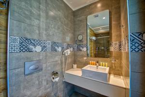 a bathroom with a sink and a mirror at Island Boutique Hotel in Rhodes Town