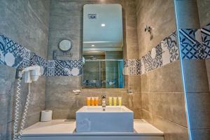 a bathroom with a sink and a mirror at Island Boutique Hotel in Rhodes Town