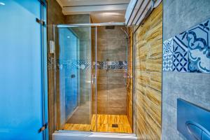 
a bathroom with a glass door and a shower stall at Island Boutique Hotel in Rhodes Town
