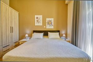 a bedroom with a large bed with two tables and two lamps at Island Boutique Hotel in Rhodes Town