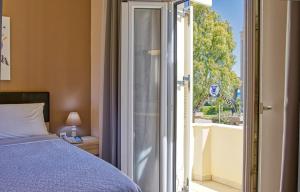 a bedroom with a bed and an open door to a balcony at Island Boutique Hotel in Rhodes Town