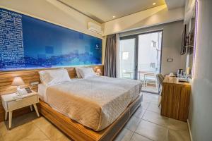 a bedroom with a bed and a large painting on the wall at Island Boutique Hotel in Rhodes Town