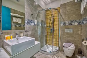 a bathroom with a sink and a shower and a toilet at Island Boutique Hotel in Rhodes Town