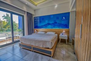 a bedroom with a bed and a large window at Island Boutique Hotel in Rhodes Town