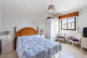 a bedroom with a bed and a desk and a tv at Fuengirola City Centre Apartment in Fuengirola