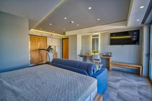 a bedroom with a blue bed and a couch at Island Boutique Hotel in Rhodes Town