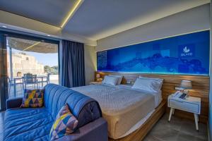 a bedroom with a bed and a couch at Island Boutique Hotel in Rhodes Town