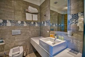 a bathroom with a sink and a toilet at Island Boutique Hotel in Rhodes Town