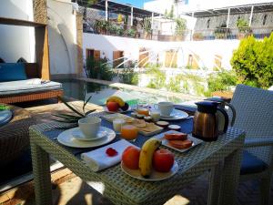 a table with breakfast food on it on a balcony at Riad Kalaa in Rabat