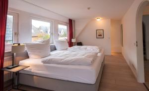 a large white bed in a room with a window at Haus Gorch Fock Strasse in Westerland