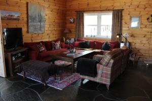 a living room with red couches and a table at Magnesplass - Dagalifjell in Dagali