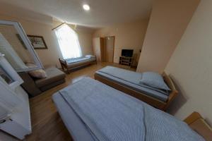 a living room with two beds and a couch at Apartments Crvena Jabuka in Ključ