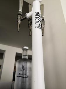 a bottle of vodka next to a roll of paper towels at Hotel Rosamar - Emar Hotels in Es Pujols