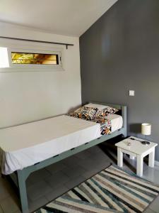 a small bedroom with a bed and a table at Oasis club in Cap Skirring