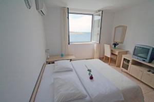 Posteľ alebo postele v izbe v ubytovaní Apartments Tamarix