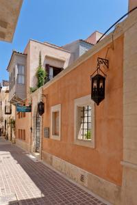 an alley in an old town with a street light at Rimondi Residences Rethymno in Rethymno Town