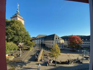 a view of a city with a clock tower and buildings at Fuchsbau unterm Krönchen in Siegen