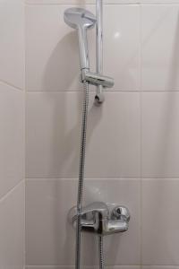 a shower with a faucet in a bathroom at Гостиница-Хостел на Промышленной in Ryazan