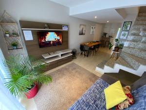 a living room with a fireplace and a couch and a table at Vila Noel Premium in Penedo
