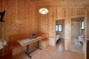 a wooden room with a bench and a sink at Casa Genziana in Barzio