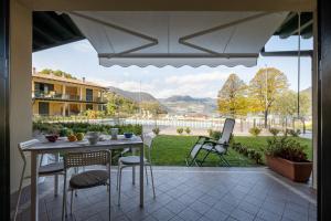 a table and chairs on a patio with a view at Fior Di Loto in Sulzano