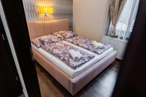 Postel nebo postele na pokoji v ubytování Allium Apartment