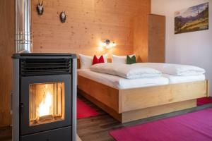 a bedroom with a bed with a fireplace in it at Ferienwohnung Heidi in Elmen