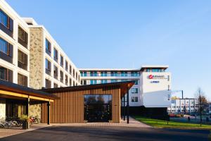 a building in front of a building at Original Sokos Hotel Kimmel Joensuu in Joensuu