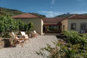 a group of chairs sitting in front of a house at Quinta da Casa Amarela- Casas da Quinta - Turismo em Espaço Rural in Lamego