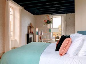 Un dormitorio con una cama grande con almohadas. en Château de la Combe, en La Celle