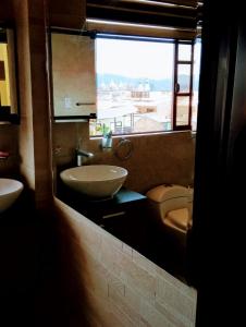 a bathroom with a sink and a toilet and a window at Casa de Huéspedes Tu Parada en Cuenca in Cuenca +116 photos
