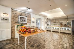 a large kitchen with a table with fruit on it at Hotel Isola Sacra Rome Airport in Fiumicino