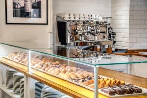 a display case filled with lots of different types of donuts at Hotel Isola Sacra Rome Airport in Fiumicino