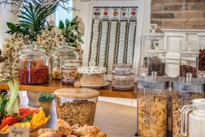 a table with jars of food and other food items at Hotel Isola Sacra Rome Airport in Fiumicino