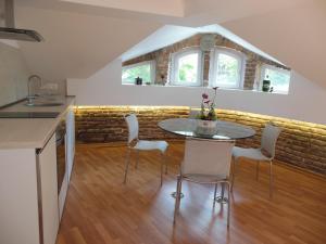 a kitchen and dining room with a table and chairs at Florence Studio in Varna City