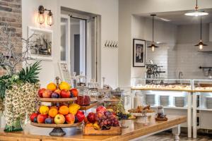 a kitchen with baskets of fruit on a table at Hotel Isola Sacra Rome Airport in Fiumicino