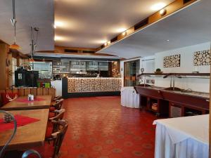 a restaurant with tables and chairs and a bar at Landhotel Albrecht in Missen-Wilhams