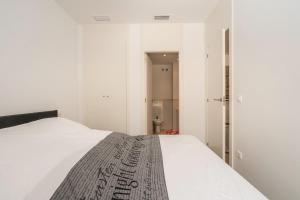 a bedroom with a white bed and a bathroom at El Bosque in Orihuela Costa +25 photos