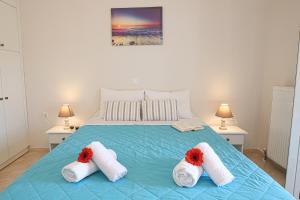 Un dormitorio con una cama con flores rojas. en Teta's house sea view, en Marathias