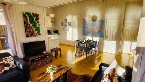a living room with a couch and a table at Langahlid Cottages & Hot Tubs in Seyðisfjörður