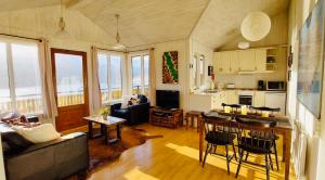 a living room with a couch and a table at Langahlid Cottages & Hot Tubs in Seyðisfjörður