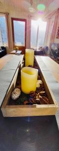 a table with two yellow bowls on top of it at Langahlid Cottages & Hot Tubs in Seyðisfjörður