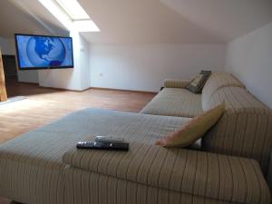 a living room with a couch and a tv at Florence Studio in Varna City