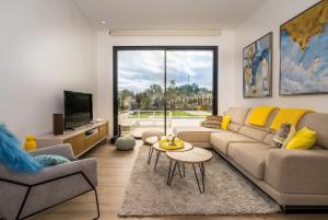 a living room with a couch and a tv at Colinas in Orihuela Costa