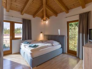 a bedroom with a bed and a large window at Ferienwohnung Pacher in Hopfgarten im Brixental