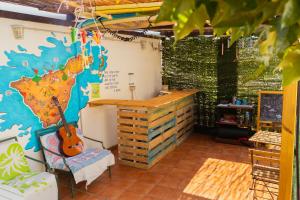 a living room filled with furniture and decorations at Arena Nest Hostel in Puerto de Santiago