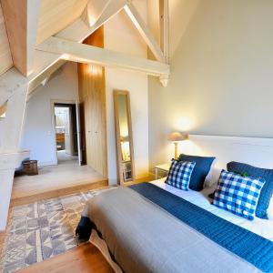 a bedroom with a large bed with blue pillows at Manoir de Malagorse in Cuzance +139 photos