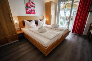 a bedroom with a large bed with white pillows at Strandhaus Eberle in Immenstaad am Bodensee
